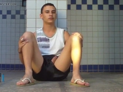 boy sitting in the douche flashes his huge knob