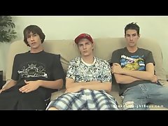 Three Twinks Relaxing On A Couch