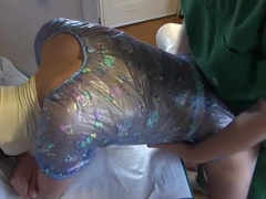 Twink In Pvc Romper Posing For