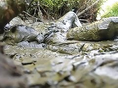NUDE MAN PLAYING IN MUD HOLE