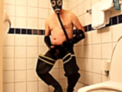 Rubbergloved draining in the motel bathroom wearing waders