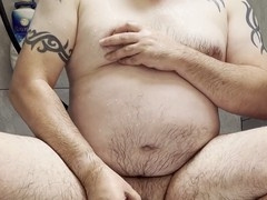 Chubby gay bear enjoys golden shower and loud cumshot in the shower