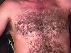 His body is covered in curly brown hair and his cock is uncut