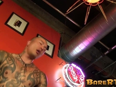 Tattoed hunk has eyes rolled backwards in pleasure