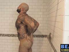 Muscular man soaps up his hairy body and pleasures his sizable manhood