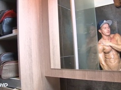 Fit and horny jock gets caught on camera jerking off his massive cock in the shower