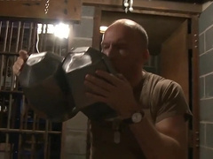 Tall man is behind jail and the balding man plays with him