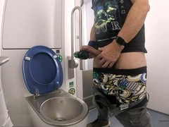 In a train bathroom, I use a wand on my huge member and let loose