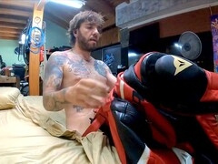 Fit guy in leather suit does a sexy striptease and masturbation with his giant cock