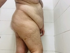 Chubby guy gets wet in the shower