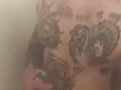 Tattooed muscle soldier in the shower