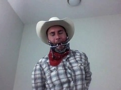 Scruffy guy in wild west setting selfgags with bit gag for gay bondage fun