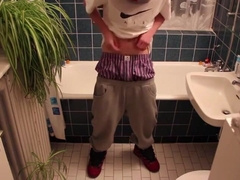Young man urinating himself