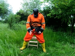 Railing Dino Plaything in Garden Dressed In Hivis and Condom Footwear