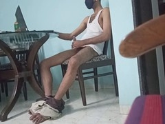 Young Indian guy milking himself at the dining table