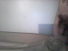 Small dick filling glass bowl with pee