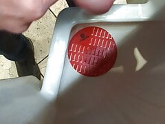 Jerking at a public urinal
