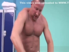 Bear receives massage from stud with oil