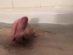 The stud relieves himself taking a tub, faps off his salami and shoots a load