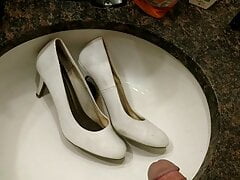 Filling white high heels with piss