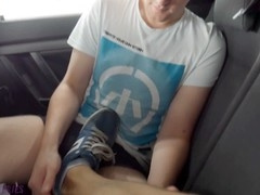 Gay twink jerks off his uncut cock in the car