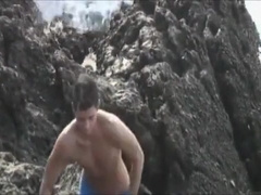 Bareback fuck on rocky beach