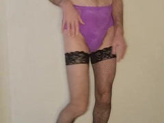 Boy dressed in purple dolls lingerie and pops on it