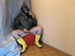 Amateur stroke session in rubber and oilskin with masturbation toy