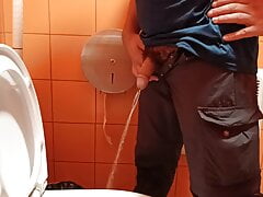 Pissing in an orange public toilet