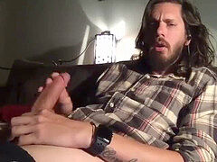 lengthy haired guy tugging of and shoots a load on cam