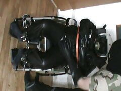 Straitjacketed slave in the wheelchair