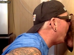 Amateur DILF at the gloryhole eagerly licks a deliciously hairy cock