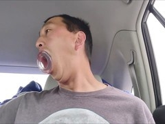 Gay Asian hunk enjoys wild car ride with giant dildo