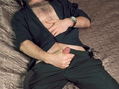 Handsome young man Noel Dero pleasures himself in a stylish suit on the bed