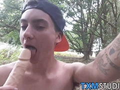 Young FTM cock rider shoves a dildo in his hole outdoors