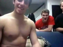 Straight hockey player giving a webcam show with team friends looking on