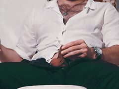 Handsome Noel Dero watches porn and caresses his dick in a condom close-up.