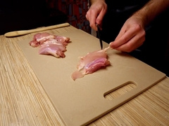 Beautiful cooking. Bare shirtlifter chef is cooking rice noodle with chicken and vegetables