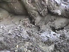 Rubber wetsuit in sticky field clay