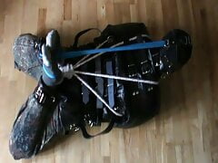 Muzzled slave is hogtied in the straitjacket