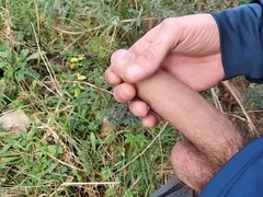 Gay hunk publicly strokes his huge cock outdoors