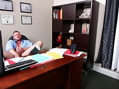 Horny Brian Bonds jerks his cock in the office