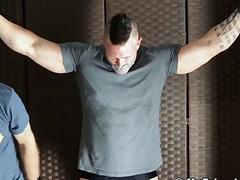 Muscular hunk tied up for gay domination and erotic tickling