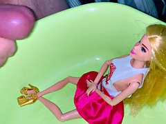 Small penis cums and pisses on a dressed Barbie doll