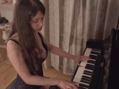 Mel gets playful at the piano while pleasuring herself with a big dildo