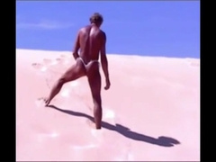 Suntanned stud on beach in lil wire panty temporarily