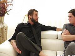 Dominant tattooed hunk barebacks mesmerized gay on couch