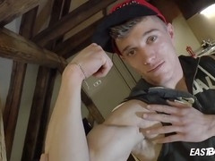 Muscular guy gives a handjob to a big gay twink