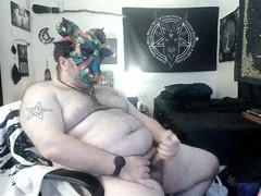 man paints voodoo, mask