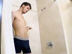 Handsome young gay smokes in the shower and jerks off